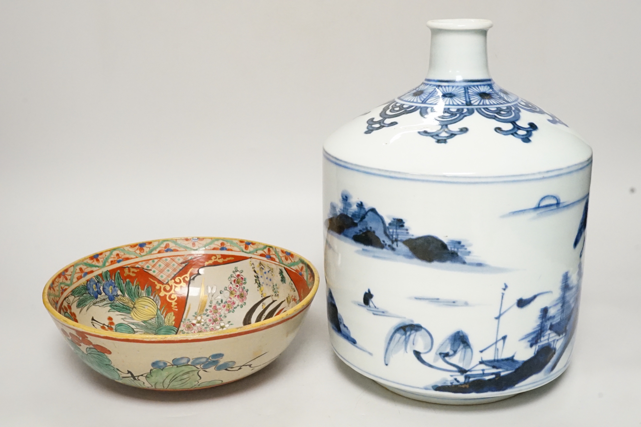 A large Japanese Arita blue and white sake flask and a Kutani bowl, largest 26cm tall